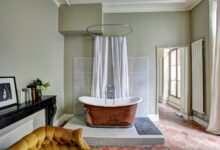 red and white bathtub near yellow fabric sofa