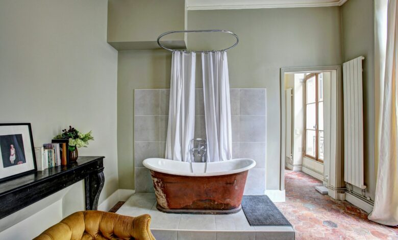 red and white bathtub near yellow fabric sofa